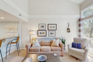 a living room with a couch and a chair at Egrets Pointe 491 in Edisto Beach