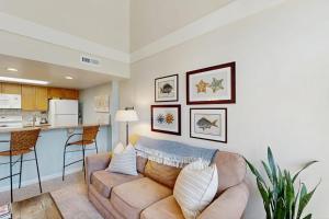 a living room with a couch and a kitchen at Egrets Pointe 491 in Edisto Beach