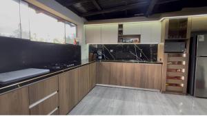 a kitchen with wooden cabinets and a counter top at villa paraíso in Piura