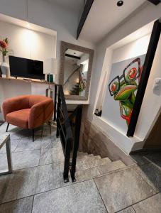 a living room with a chair and a mirror at Maison Stanislas Spa Suites in Nancy +5 photos