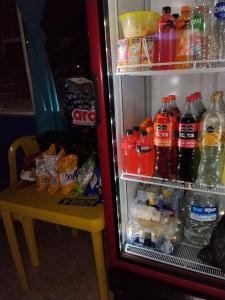 a refrigerator filled with lots of drinks and a table at Hospedaje Mundial in Villeta +22 photos