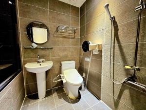 a bathroom with a toilet and a sink at If Business Hotel in Changwon