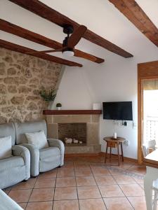 a living room with a couch and a fireplace at Casa Carmeta Beceite in Beceite +8 photos
