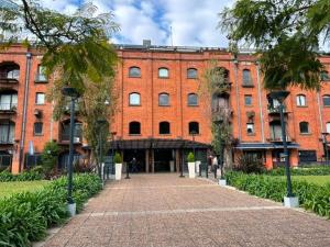 a red brick building with a brick walkway in front at Departamento al Canal in Buenos Aires