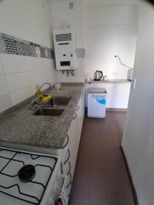 a small kitchen with a sink and a stove at Departamento al Canal in Buenos Aires
