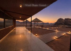 a walkway with lights and a view of the mountains at WADI RuM GRAND in Wadi Rum