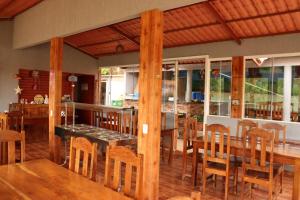 a dining room with wooden tables and chairs at Pousada Recanto dos Buritis in Manhã +11 photos