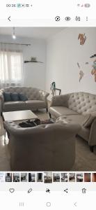 a living room with two couches and a table at Opera d'Alger in Ouled Fayet