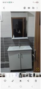 a bathroom with a white sink and a mirror at Opera d'Alger in Ouled Fayet