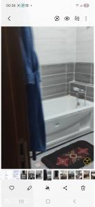a picture of a bathroom with a sink and a tub at Opera d'Alger in Ouled Fayet