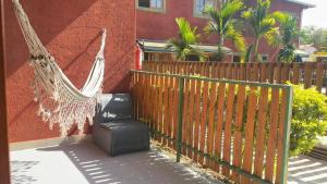 a hammock hanging from a fence next to a building at Pousada Iandara in Pirenópolis