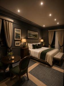 a bedroom with a bed and a table and chairs at Kinsale Suites in Nettuno