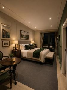 a bedroom with a bed and a table and a couch at Kinsale Suites in Nettuno