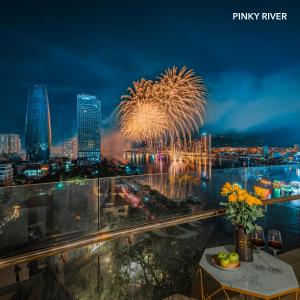 a view of a fireworks display from a hotel room at PinkyRiver in Danang
