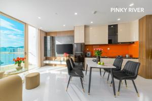 a kitchen and dining room with a table and chairs at PinkyRiver in Danang