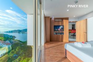 a bedroom with a view of the water at PinkyRiver in Danang