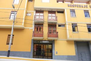 a yellow building with windows and balconies on it at Hotel La Reserva INN in Ayacucho