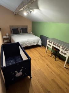 a bedroom with a bed and a desk at Les nids de la chevêche in Saint-Pierre-de-Juillers +51 photos