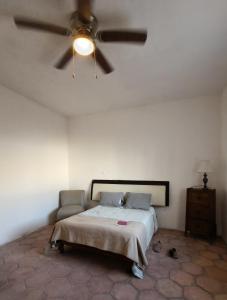 a bedroom with a bed and a ceiling fan at Tu hostalito en Parras in Santa Isabel