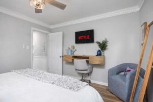 a bedroom with a bed and a chair and a desk at Lake Oliver Cottage Near Fort Benning & Downtown Columbus in Columbus