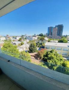 a balcony with a view of a city at Departamento Centro Chillán in Chillán