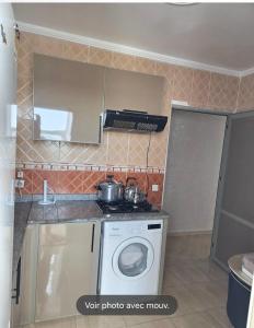 a kitchen with a washing machine and a sink at Oualidia résidence Ben zeroual in Oualidia