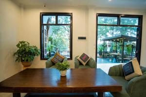 a living room with a wooden table and chairs at Pine Hill Villa Sapa in Sapa