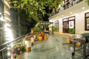 a building with a bunch of flowers and plants at Pine Hill Villa Sapa in Sapa