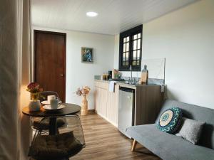 a living room with a table and a kitchen at Villa Cinco Boquete in Alto Boquete