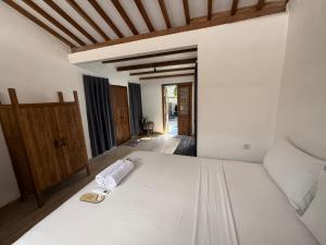 a bedroom with a white bed with towels on it at Nextdoor Rooms in Yogyakarta +85 photos