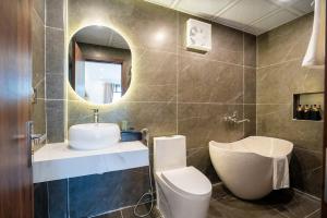 a bathroom with a sink and a toilet and a mirror at Pine Hill Villa Sapa in Sapa +87 photos