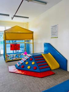 a childs play room with a play set and an aquarium at ONE PAVILLION PLACE in Cebu City +25 photos