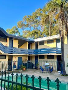 a building with a pool in front of it at Pathfinder Motel in Melbourne