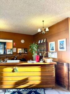 a kitchen with a wooden counter and a sink at Pathfinder Motel in Melbourne