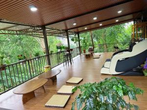 a room with a balcony with tables and chairs at Kingfisher Nest in Hai Phong
