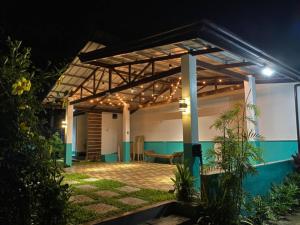 a patio of a house at night at Kia Ora Villa Staycation in Los Baños