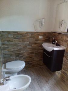 a bathroom with a toilet and a sink at Appartamento Scirocco in Marina di Campo