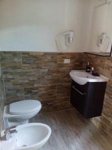 a bathroom with a toilet and a sink at Appartamento Scirocco in Marina di Campo