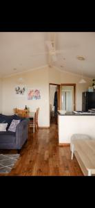 a living room with a couch and a table at Waves & Wildlife Cottages Kangaroo Island in Stokes Bay