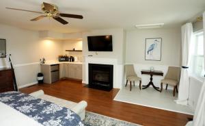 a living room with a bed and a fireplace at Cypress River Inn & Spa in Snow Hill