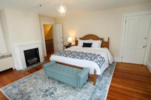 a bedroom with a large bed and a fireplace at Cypress River Inn & Spa in Snow Hill