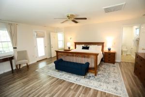a bedroom with a bed and a blue chair at Cypress River Inn & Spa in Snow Hill