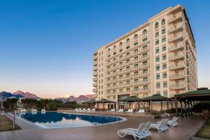 a large building with a pool in front of it at Crowne Plaza Antalya by IHG in Antalya
