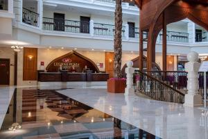 a lobby of a hotel with a palm tree at Crowne Plaza Antalya by IHG in Antalya +175 photos