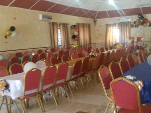 a room with a bunch of chairs and a table at RockView Hotel in Tongo