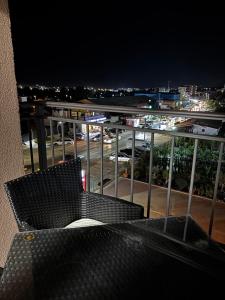 a chair on a balcony with a view of a parking lot at Apartmani B&A in Ulcinj