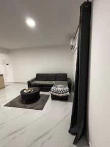 a living room with a couch and a table at Apartmani B&A in Ulcinj