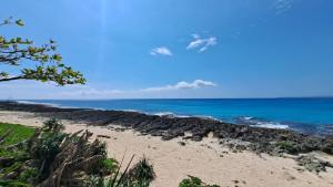a beach with the ocean in the background at Bai Ji Yi B&B in Hengchun South Gate