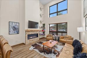 a living room with a couch and a fireplace at Luxury Red Lodge Retreat Hot Tub Downtown in Red Lodge