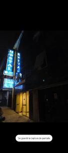 a building with blue signs on the side of it at Deluxe Miraflores in Miraflores